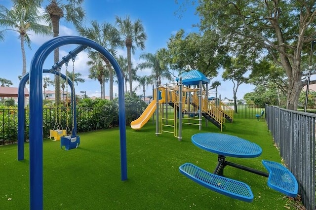 view of playground with a lawn