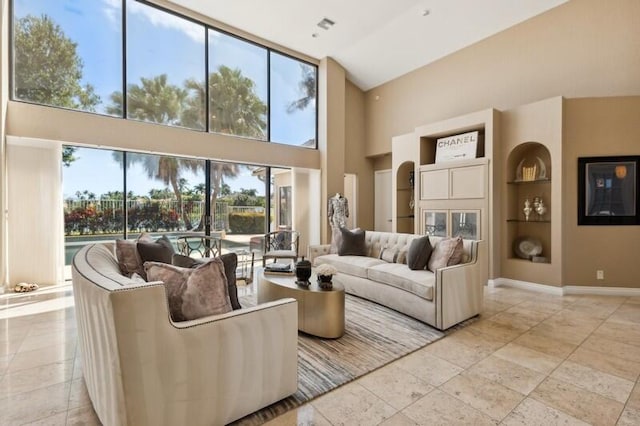 living room featuring high vaulted ceiling and built in features