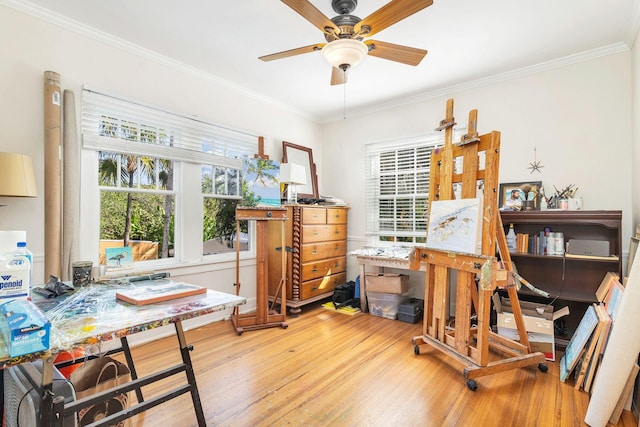 office space with ceiling fan, light hardwood / wood-style flooring, and ornamental molding