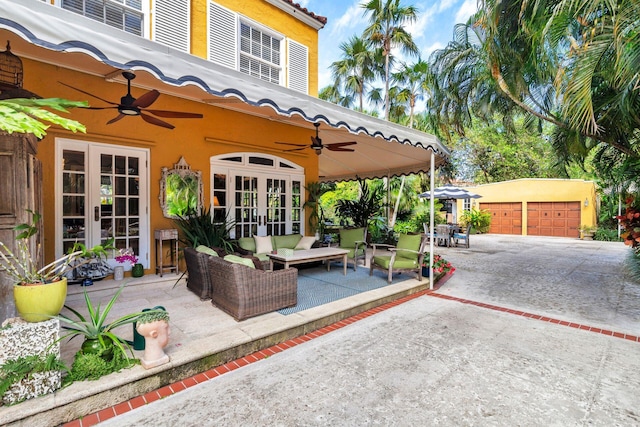 view of patio / terrace featuring french doors, an outdoor living space, an outdoor structure, and a garage