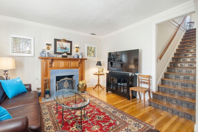 living room featuring crown molding and hardwood / wood-style floors