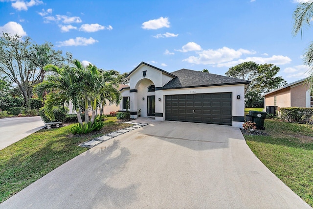 view of front facade with a garage, central AC unit, and a front lawn