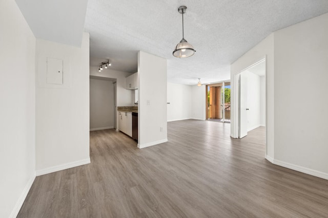 interior space featuring rail lighting, a textured ceiling, wood-type flooring, and ceiling fan