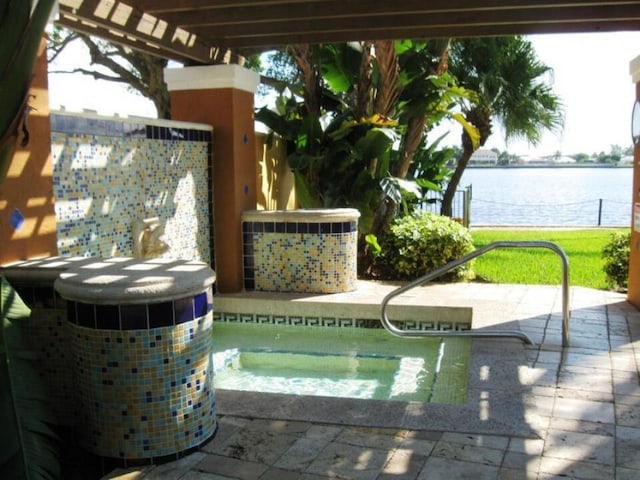 view of pool with a pergola, a patio, and a water view