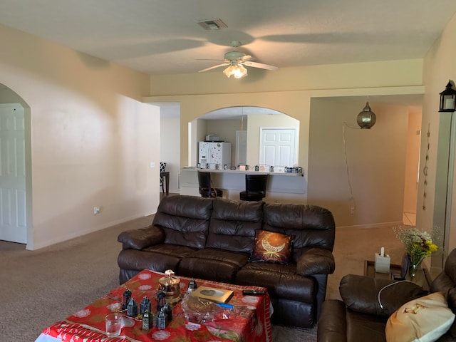 living room featuring carpet flooring and ceiling fan