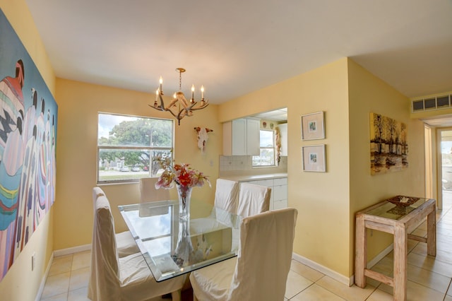 tiled dining area featuring a chandelier and a wealth of natural light