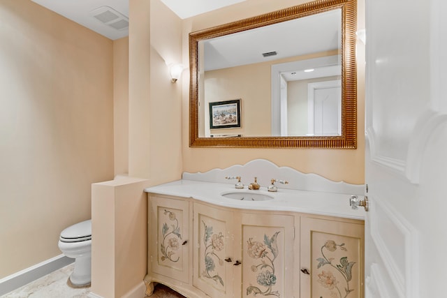 bathroom with tile floors, toilet, and vanity