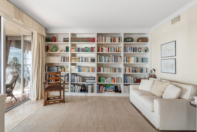 sitting room with plenty of natural light, ornamental molding, and carpet flooring