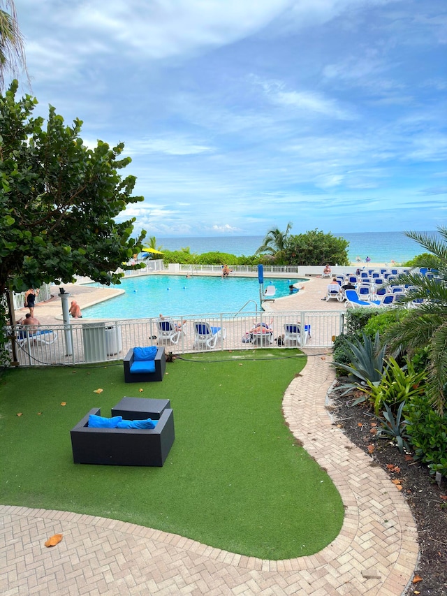 view of swimming pool featuring a water view