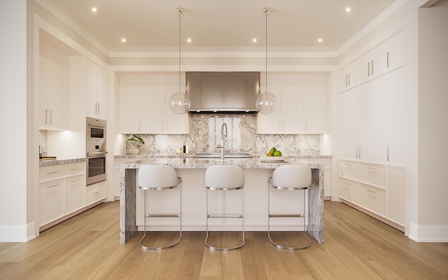 kitchen with light wood-type flooring and white cabinetry