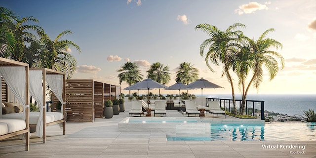 pool at dusk featuring a water view and a patio area