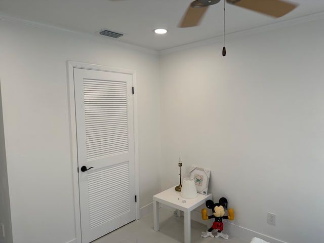 interior space with ceiling fan and crown molding