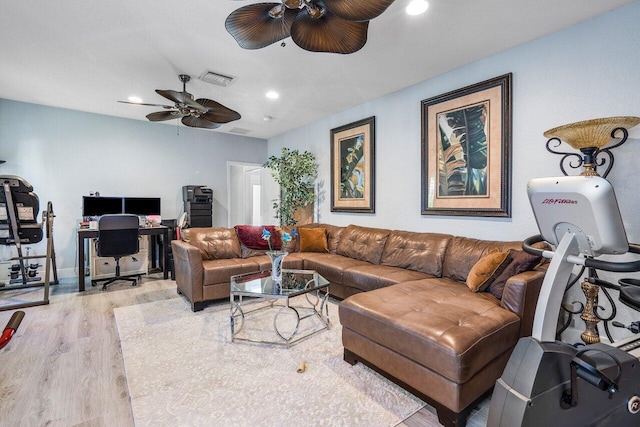 living room with light hardwood / wood-style floors and ceiling fan