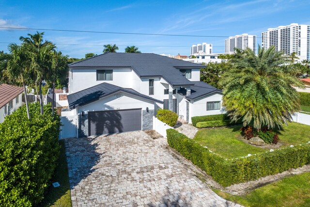 view of front of property with a front lawn and a garage