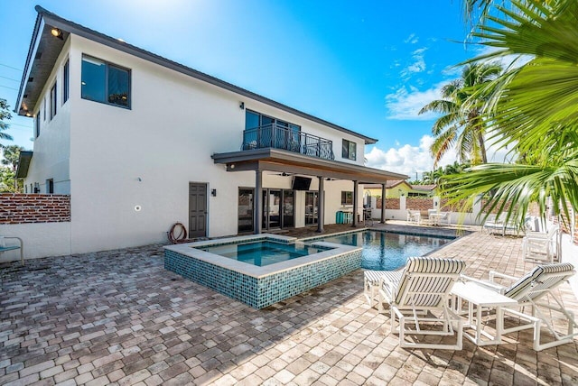 view of pool featuring an in ground hot tub and a patio area