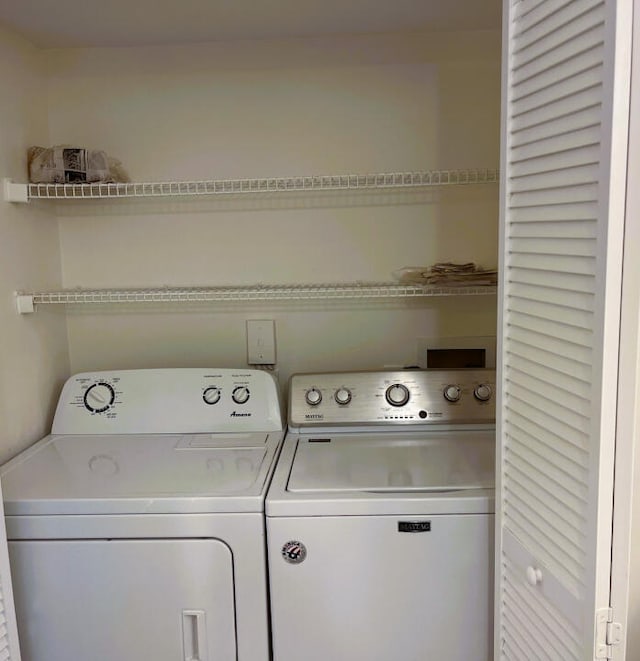 laundry area with washing machine and clothes dryer