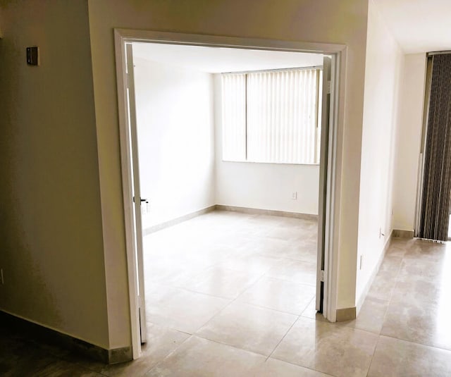 corridor featuring light tile flooring