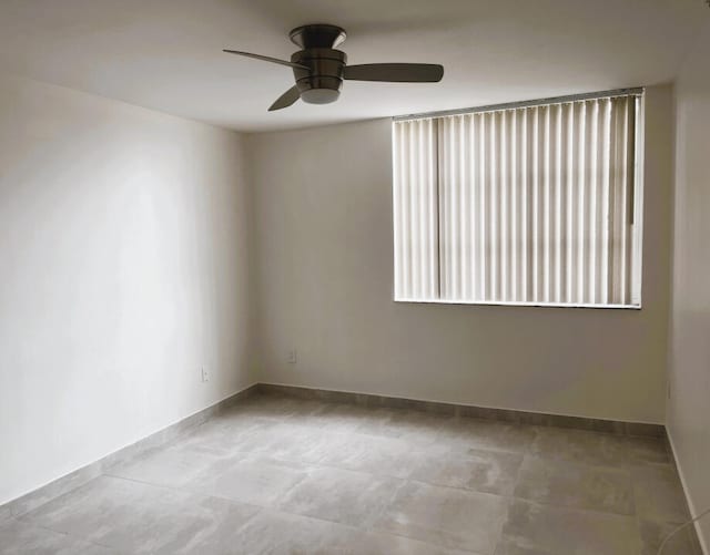 unfurnished room with light tile flooring and ceiling fan