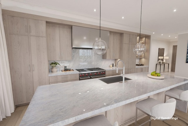 kitchen featuring a kitchen bar, decorative light fixtures, light brown cabinetry, sink, and light stone countertops