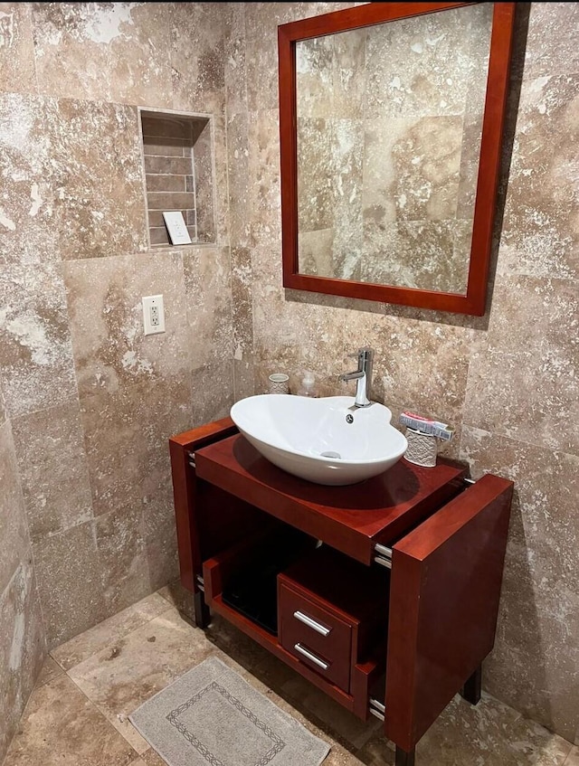 bathroom with vanity, tile walls, and tile floors