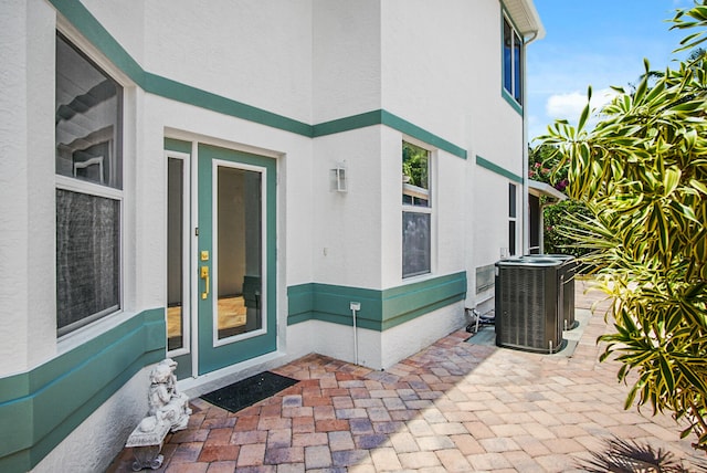 doorway to property with a patio and central air condition unit