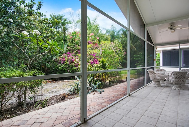 unfurnished sunroom with ceiling fan and lofted ceiling