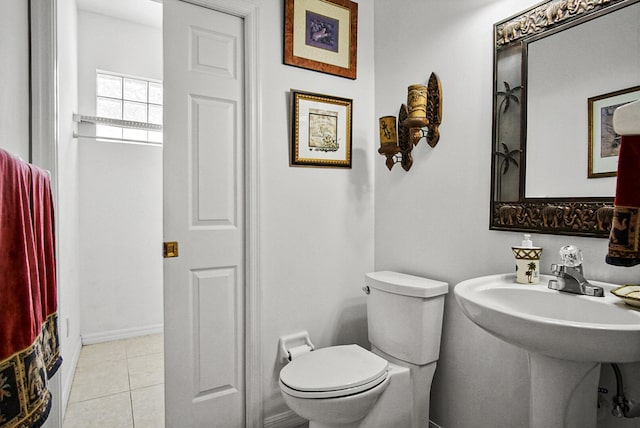 bathroom featuring sink, toilet, and tile floors