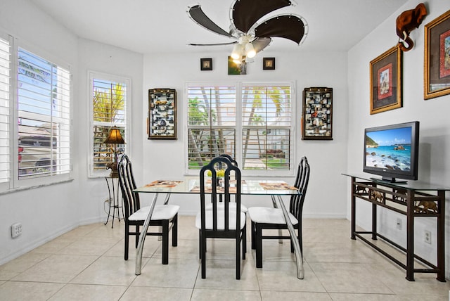 dining area with a healthy amount of sunlight, ceiling fan, and light tile flooring