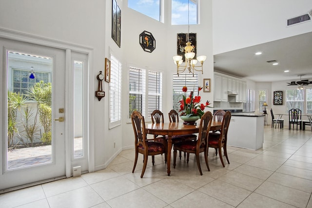 dining space with light tile flooring and ceiling fan with notable chandelier