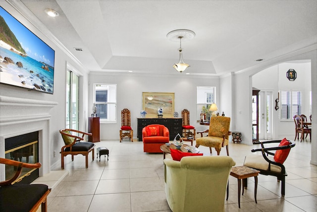 tiled living room featuring plenty of natural light and a raised ceiling