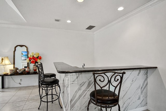 bar with ornamental molding and light tile floors