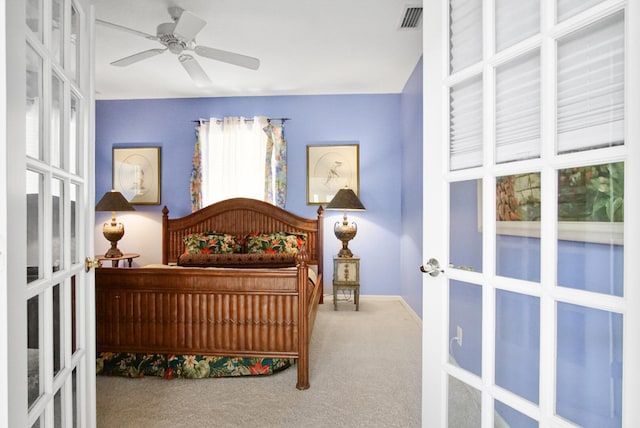 bedroom with carpet flooring, ceiling fan, and french doors