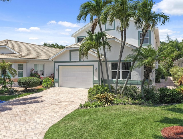 view of front facade featuring a front yard and a garage