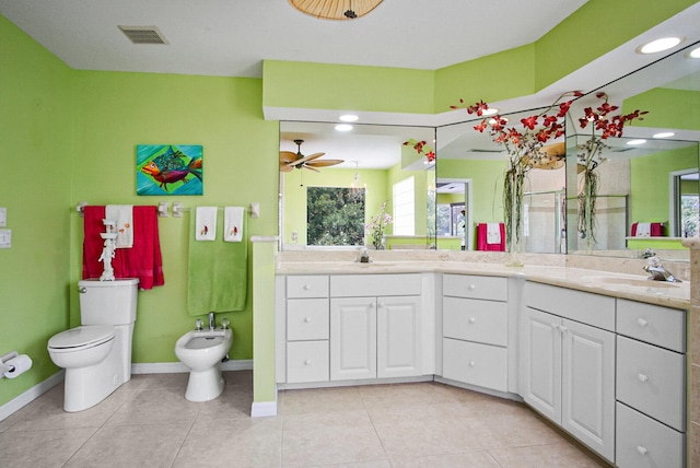 bathroom featuring ceiling fan, tile flooring, double vanity, a bidet, and toilet