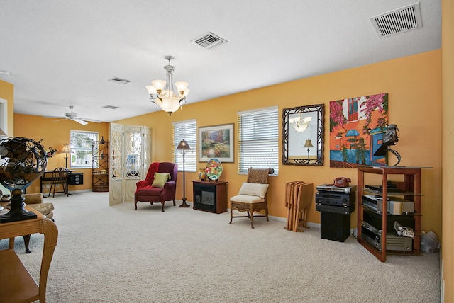 interior space with carpet flooring and ceiling fan with notable chandelier