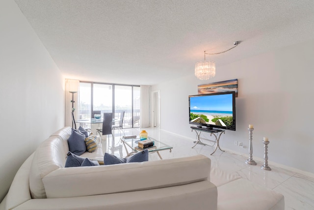 tiled living room with a chandelier, a healthy amount of sunlight, expansive windows, and a textured ceiling