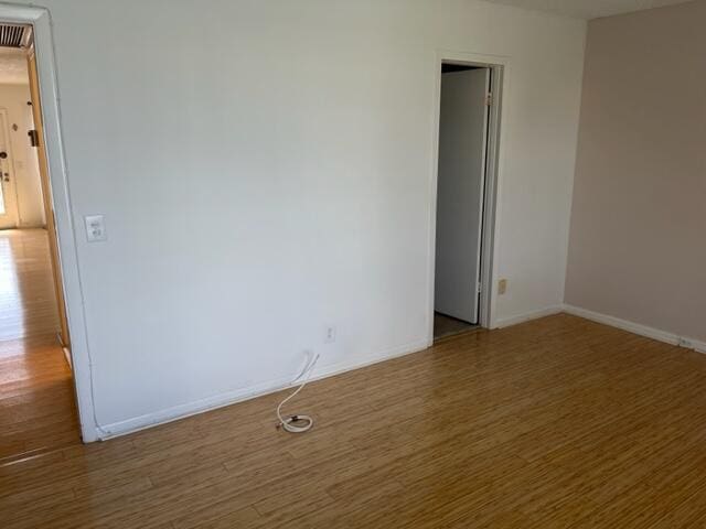 spare room featuring dark hardwood / wood-style floors