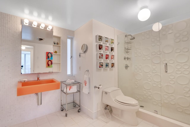 bathroom featuring an enclosed shower, toilet, tile floors, and sink