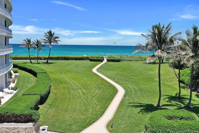 view of home's community with a water view and a yard