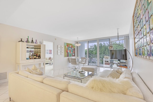 tiled living room with an inviting chandelier and a wall of windows