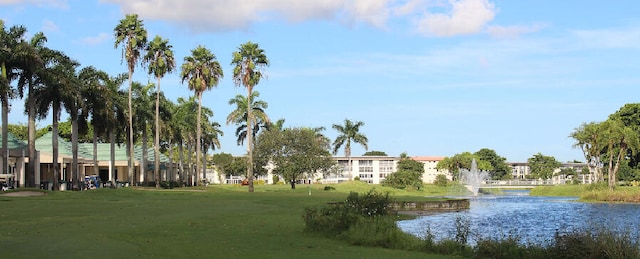 view of community featuring a yard and a water view