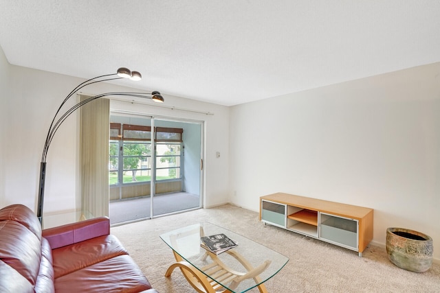 living room with light carpet and a textured ceiling