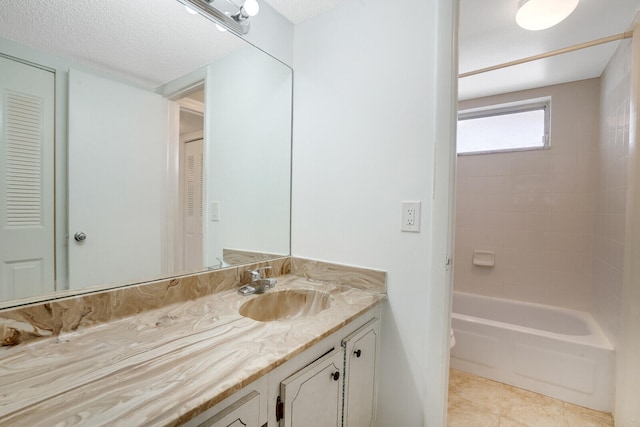 full bathroom with toilet, vanity with extensive cabinet space, shower / bathing tub combination, tile floors, and a textured ceiling