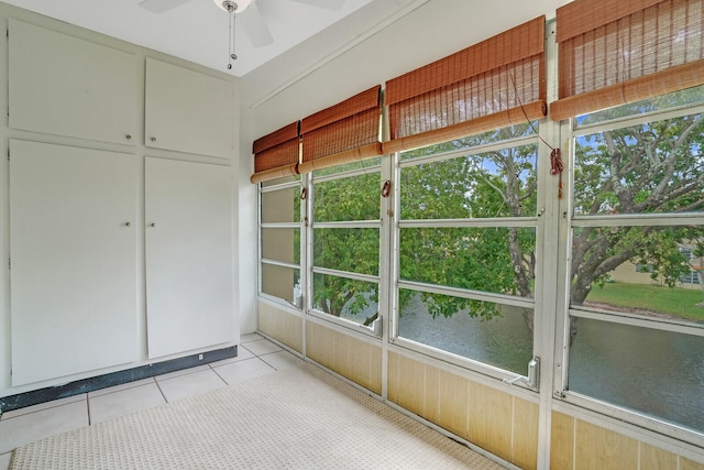 unfurnished sunroom with ceiling fan