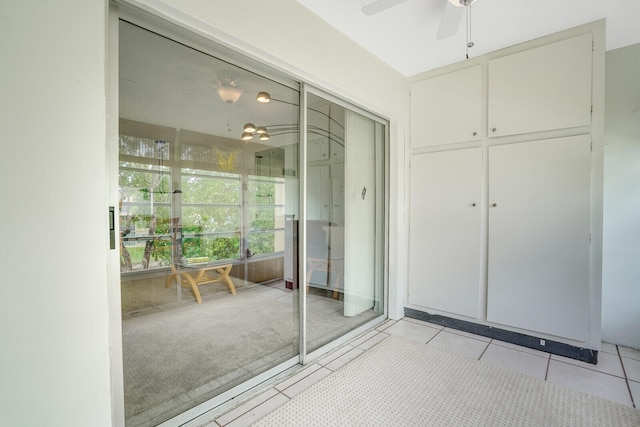 interior space with ceiling fan