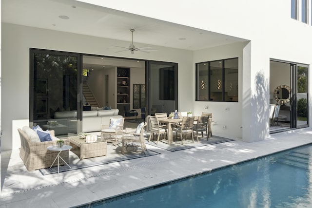 exterior space with stucco siding, a patio, an outdoor pool, an outdoor hangout area, and ceiling fan