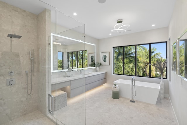 full bathroom with a freestanding bath, a healthy amount of sunlight, and a stall shower