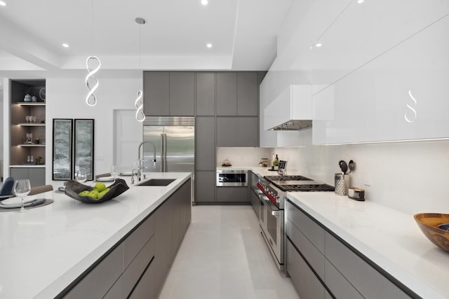 kitchen featuring a sink, high end appliances, modern cabinets, and gray cabinetry