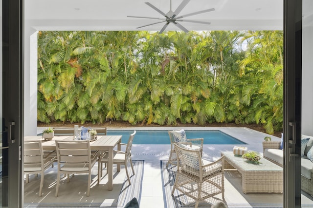 pool featuring a ceiling fan, outdoor dining area, and a patio area