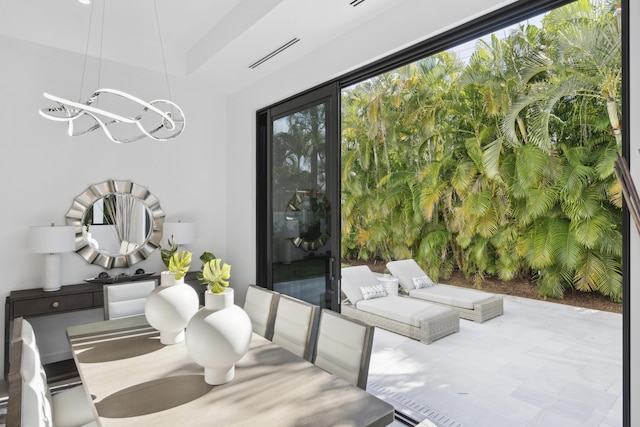 dining area featuring visible vents and a notable chandelier